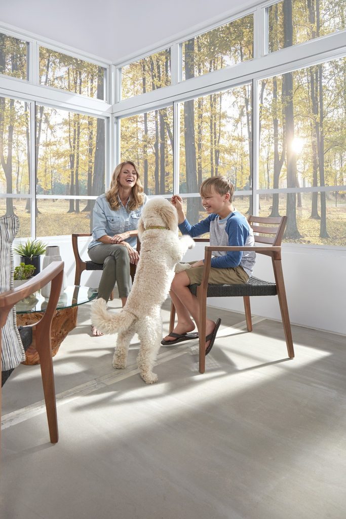 Image of family enjoying time in front of horizontal side-slider window panels.